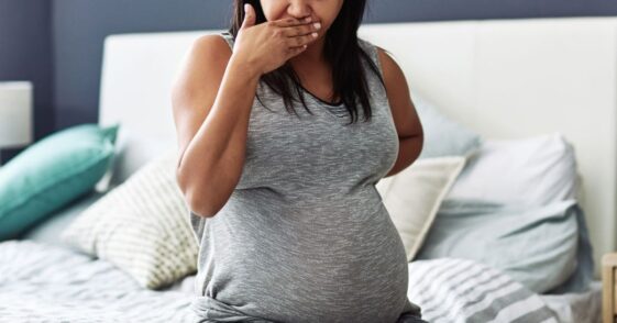 Cropped shot of a pregnant woman feeling nauseous.