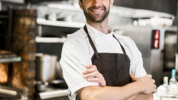 Chef in kitchen with arms crossed