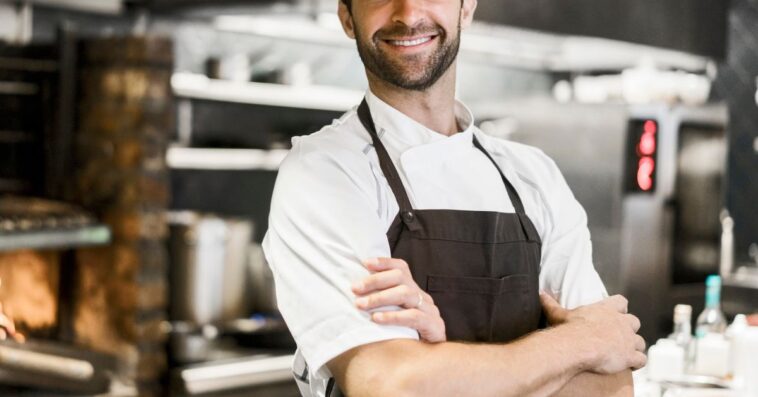 Chef in kitchen with arms crossed