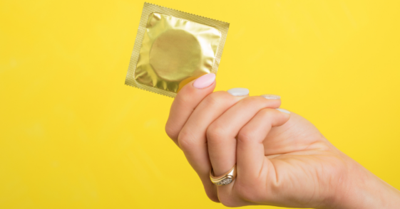 Woman holding a condom