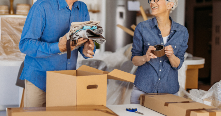 Older couple packing moving boxes