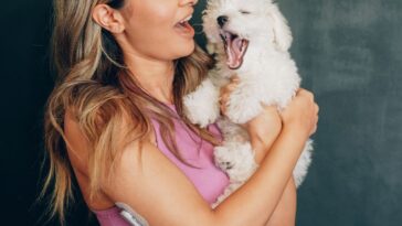 Woman holding pet dog