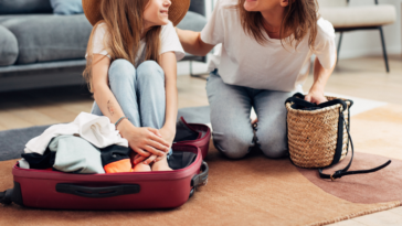 Mom packing kids' bags for a trip