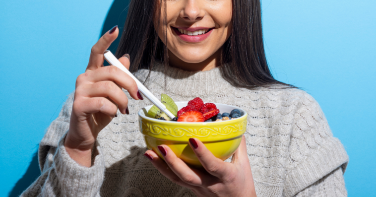 young woman with bowl of fruit