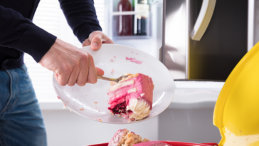 man throwing away birthday cake