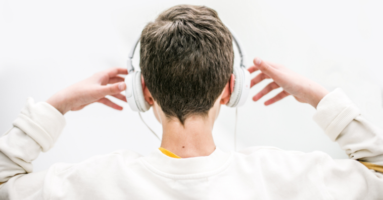 back of young person wearing headphones