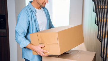 man carrying moving boxes