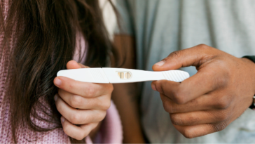 Couple holding pregnancy test