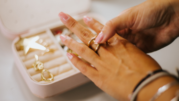 Woman trying on jewelry from jewelry box