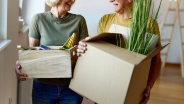 Happy senior couple talking while moving into a new home.