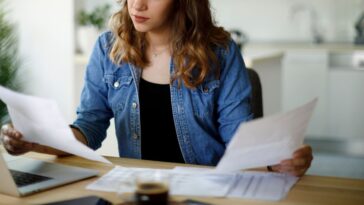 Serious young woman working at home.