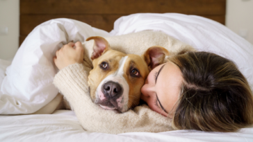 Woman snuggling with her dog