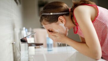 Teen girl washing her face