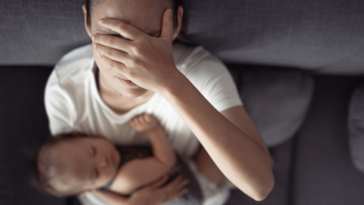 Stressed out mom holding her baby