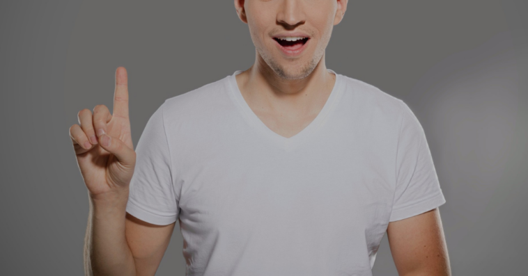 man holding up index finger with excited look on his face