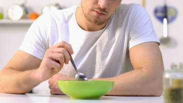 unhappy man with a bowl of stew