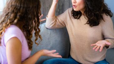 Woman argues with her teenage daughter while sitting at home.