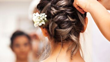 Back shot of a bride's hair being fashioned on her wedding day.