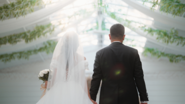 A man walking a bride down the aisle.