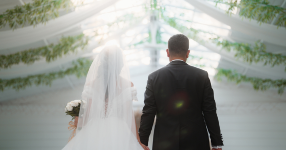 A man walking a bride down the aisle.