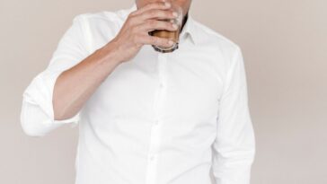 Businessman drinking a latte from a glass.