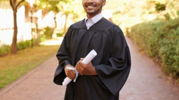 Cropped portrait of a handsome young man posing with his degree on graduation day.