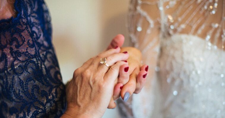 Mother of the bride holding her hand.