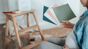 Pregnant woman decorating her nursery