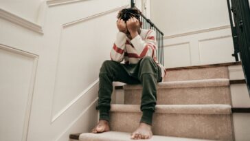 Sad teen sitting on the stairs.