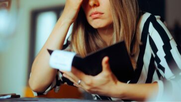 Unhappy female customer looking at a restaurant bill