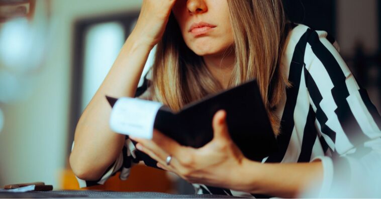 Unhappy female customer looking at a restaurant bill