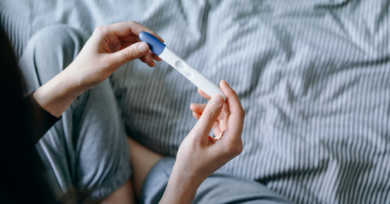 Person looking at a pregnancy test