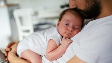 Father holding sleeping infant