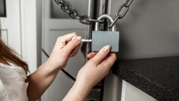 Person putting lock on refrigerator door