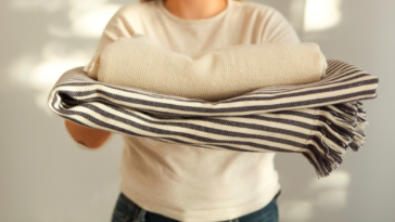 Woman holding extra blankets