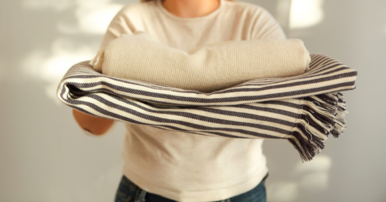 Woman holding extra blankets