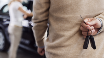 A guy holding car keys