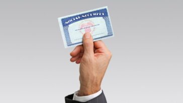 Close-up of hand holding a social security card