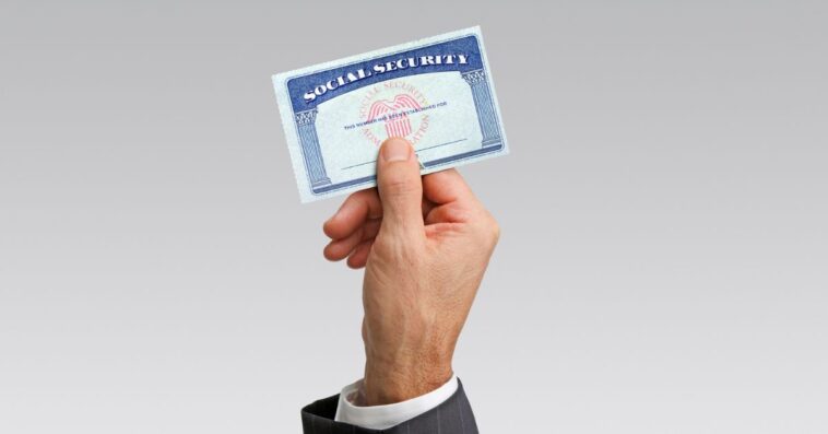 Close-up of hand holding a social security card