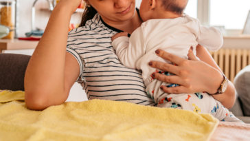 Upset mom holding her baby