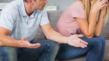 Couple sitting on the couch having a fight