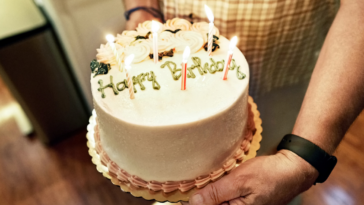 Guy holding a birthday cake