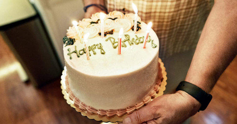 Guy holding a birthday cake