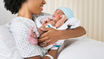 mother holding newborn baby in hospital