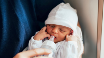 man holding newborn baby