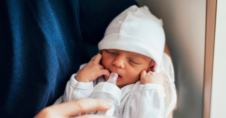 man holding newborn baby
