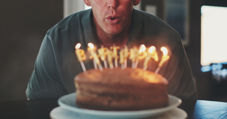 Guy blowing out his birthday candles