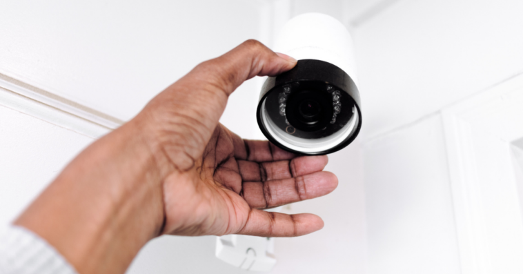 Person installing in-home security cameras