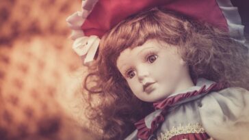 Close-up shot of a porcelain doll at a flea market.