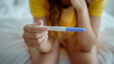 Woman looking at a pregnancy test